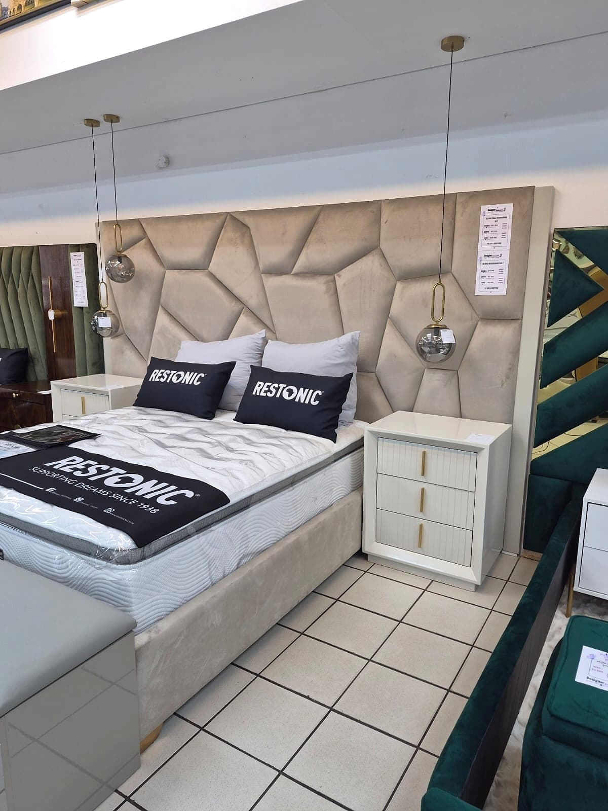 Beige faceted headboard bed frame in a styled bedroom
