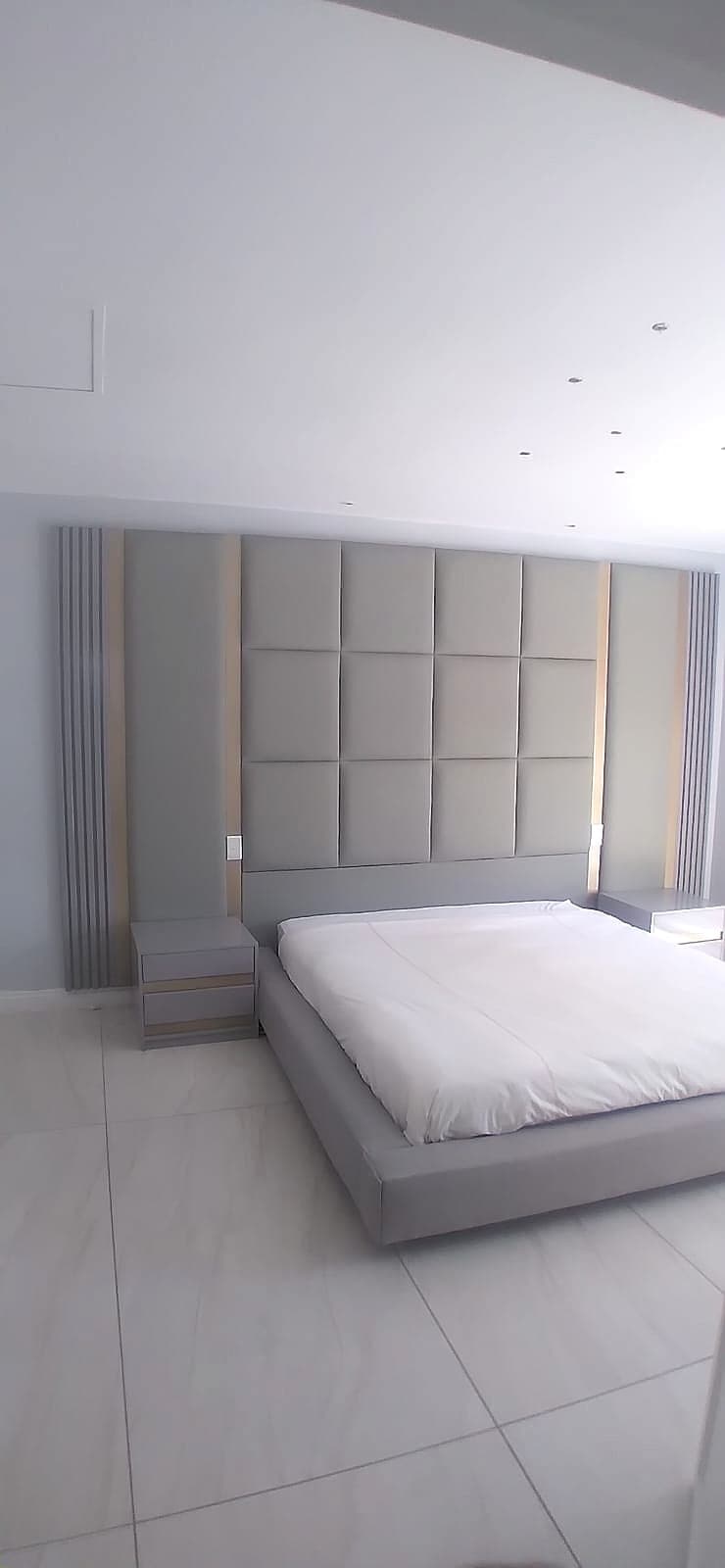 Grey square-tufted panel headboard — custom upholstery