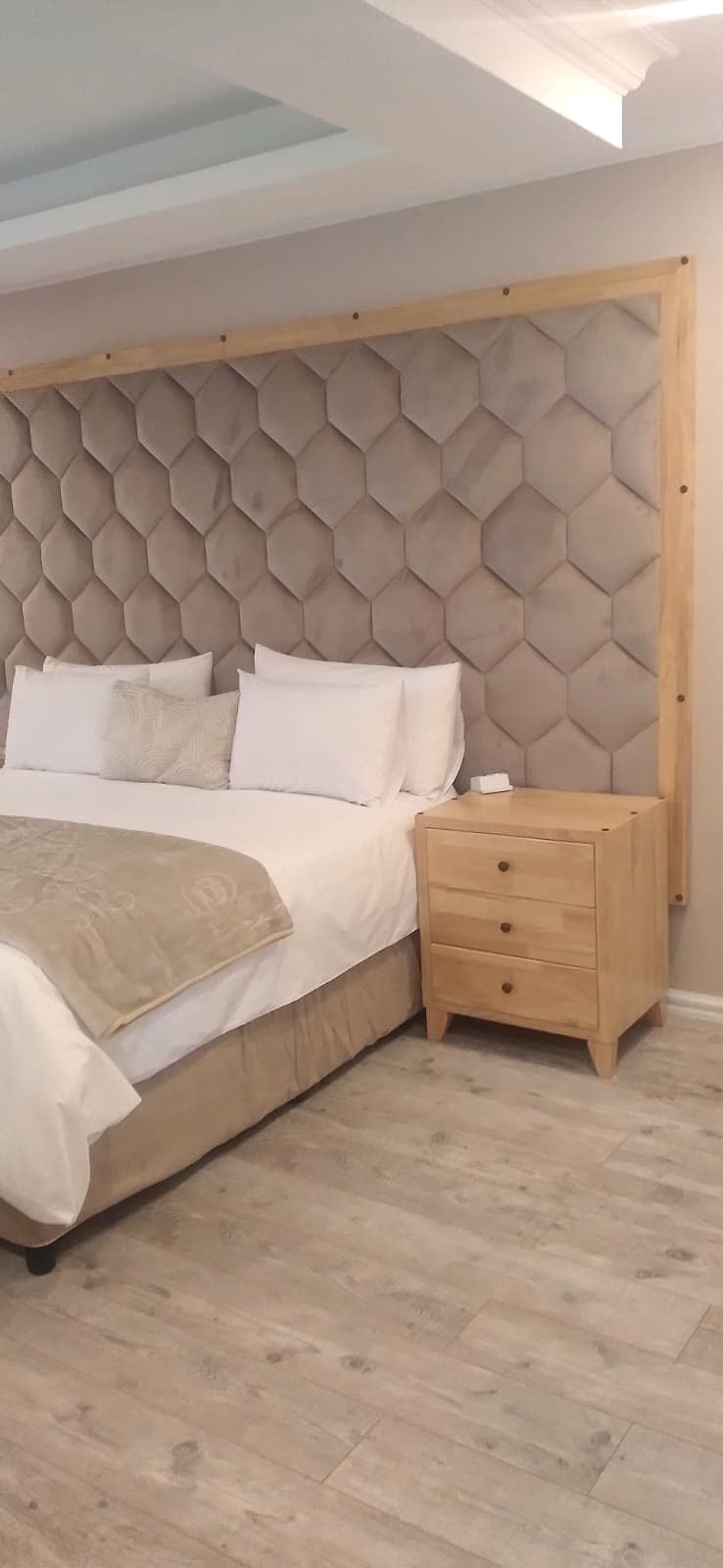 Honeycomb-tufted headboard with exposed wood frame — a bespoke commission