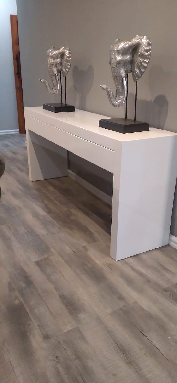 Styled console table with elephant sculptures in a Lavish Haus living space