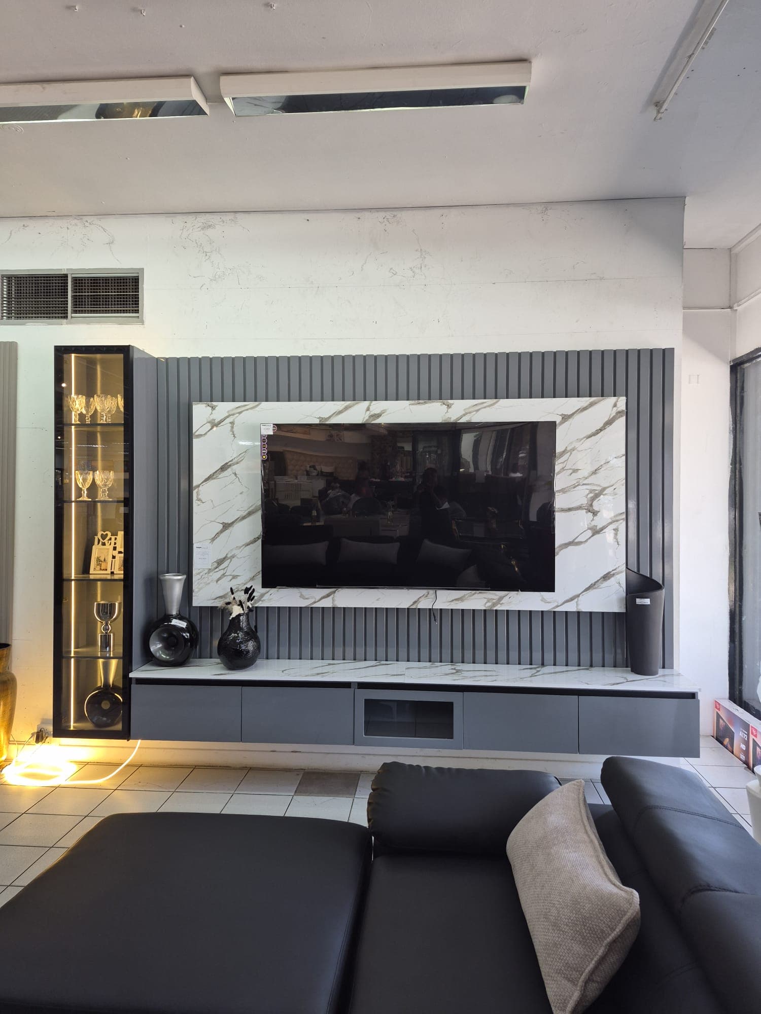 TV wall console with sofa in foreground